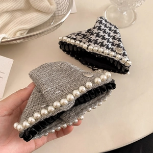 Houndstooth and grey tweed hair claws with pearls and metal buckle on desk