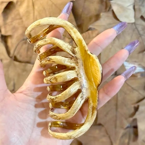 Macro detail of amber marble hair claw clip with high-quality resin texture