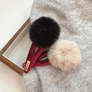 Barrettes à cheveux pompon en fausse fourrure avec étiquette or sur velours rouge