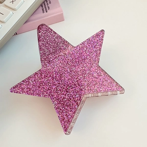 Detail view of a pink glitter star hair claw clip made of transparent acrylic material