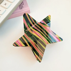 Detailed close-up of a glossy star-shaped hair claw clip with colorful striped patterns