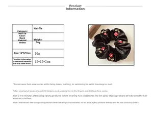Detail view of black velvet hair scrunchie with red flower embroidery and 12cm size