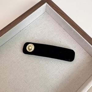 Minimalist black velvet BB hair clip with vintage gold metal button and rounded edges