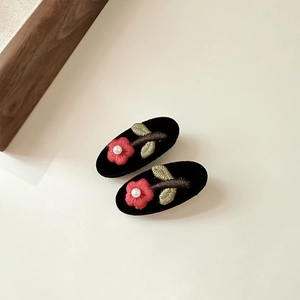 Floral embroidered black velvet hair clips with red flowers and white pearl accents