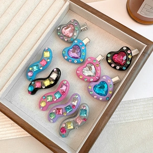 Detailed macro view of 10 colorful Y2K heart and wave hair clips with sparkling rhinestones