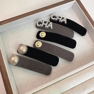 Elegant 6-piece velvet hair clip set with rhinestones and pearls on a beige linen tray