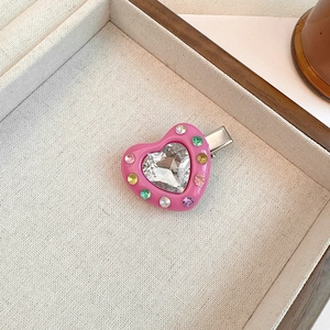 Detail of pink heart hair clip with colorful crystals and silver duckbill metal grip