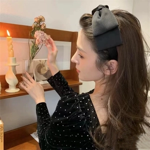 Elegant large black velvet bow headband for women in a vintage retro style aesthetic
