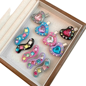 Sweet 9-piece heart and wave hair clip set with colorful rhinestones in a wooden tray