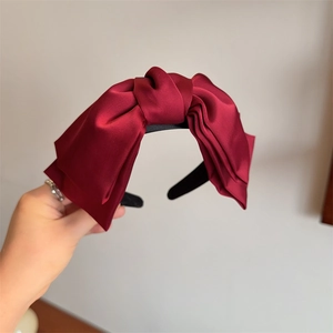 Elegant wine red satin bow headband for women featuring a glossy silk-like finish for styling