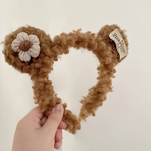 Detailed plush brown bear headband with crochet flower and vintage woven label texture