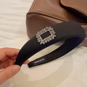 Elegant black padded velvet headband with a sparkling rectangular crystal buckle