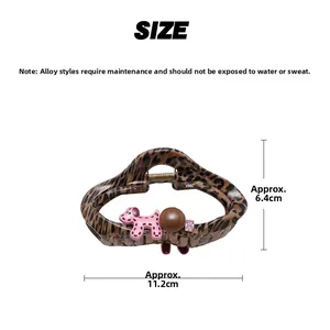 Size chart showing leopard print hair claw with pink puppy and alloy dimensions 11.2cm