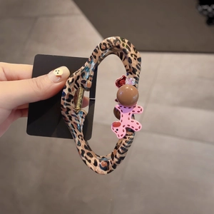 Leopard print shark clip with pink balloon dog, red flower, and brown bead accents