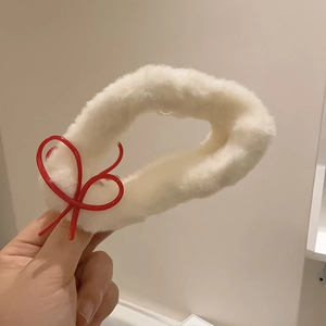 Furry white shark hair claw clip with a red bow detail for women winter hairstyles