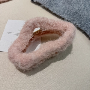 Pink plush hair claw clip for women featuring fuzzy faux fur and a large elegant shape