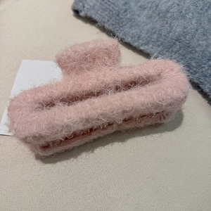 Close-up of pink plush hair claw clip featuring warm faux mohair texture for autumn and winter
