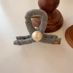 Elegant grey knit fabric hair claw clip with cream pearl and gold label for women