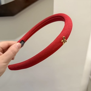Elegant red ribbed sponge headband with gold butterfly charm and handmade tag