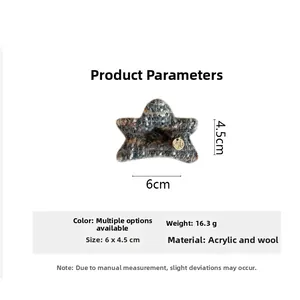 Detailed view of grey wool star hair claw clip with gold tag and size 6x4.5cm