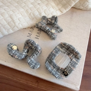Elegant grey tweed claw clips in star and oval shapes with small metal charms