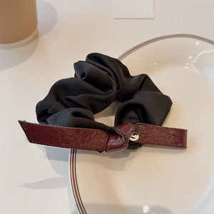 Elegant black satin scrunchie with a burgundy leather bow and silver letter pendant charm