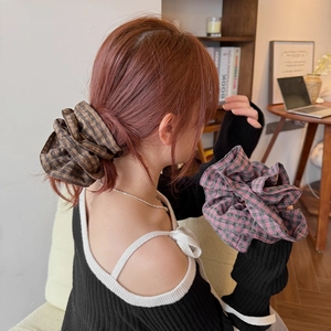 Close-up of vintage plaid scrunchie with soft cotton texture and elastic band