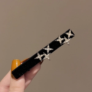 Elegant black velvet side hair clip featuring five sparkling rhinestone star decorations