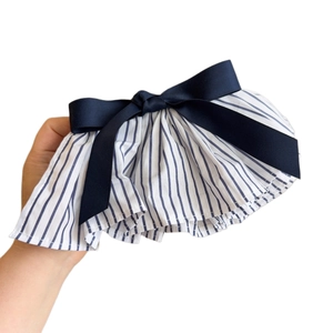 Blue and white striped fabric hair clip featuring a navy satin bow in nautical style