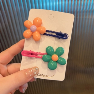 Cute set of two colorful flower hair clips for girls on a white display card
