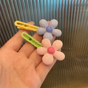 Charming floral hair clips for girls in vibrant pink and purple resin with scalloped edges
