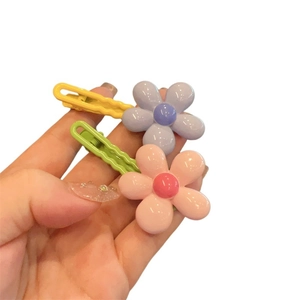 Pink and purple flower hair clips for girls with a wavy non-slip grip design