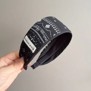 Bohemian paisley print wide fabric headband with handmade label in black and white