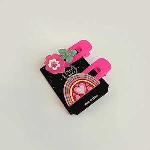 Détail de pinces à cheveux roses avec fleur cactus et arc-en-ciel sur carte
