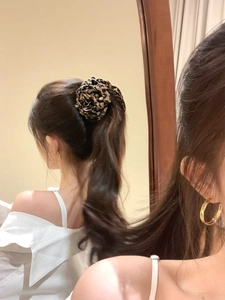 Chic leopard print large flower scrunchie on a high ponytail in a mirror selfie