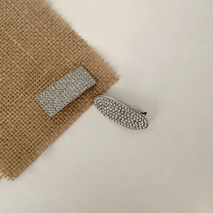 Elegant rhinestone hair clip set with rectangular and oval designs on a linen background