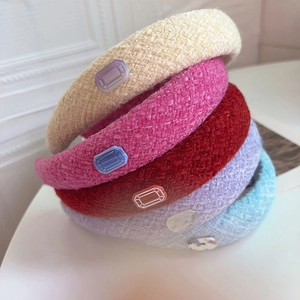 Detail of bouclé wool tweed headbands showing thick texture and emerald-cut resin gems