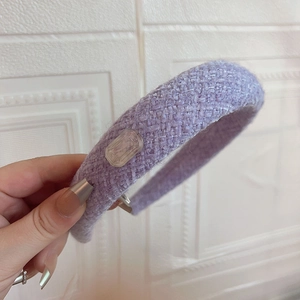 Detailed texture of lavender wool tweed headband with clear interlocking woven pattern
