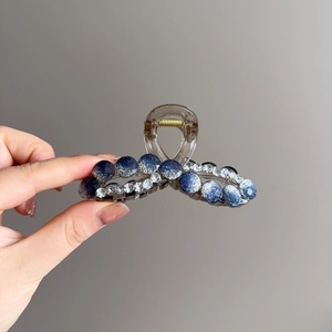 Elegant crystal hair claw clip with blue gradient accents and sparkling rhinestones