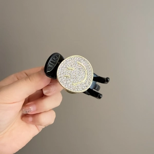 Elegant black hair claw clip featuring a sparkling rhinestone smiley face design for women