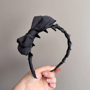 Elegant black bow headband with sparkling rhinestones and inner comb for secure styling