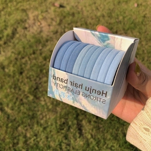 Close-up of blue gradient high-elasticity hair bands in small paper packaging box