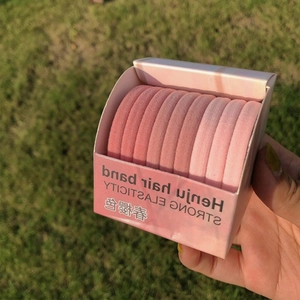 Outdoor shot of gradient pink high elasticity hair bands in a branded gift box