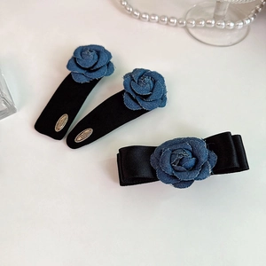 Vintage denim rose bow hair clip set with black satin details on white background