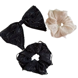Three-piece hair accessory set featuring mesh scrunchies and a black bow clip with silver glitter