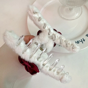 Detailed macro view of white plush hair claw clip with elegant deep red satin rose flower