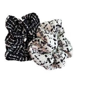 Set of two black and white plaid tweed scrunchies with elegant knit texture for women