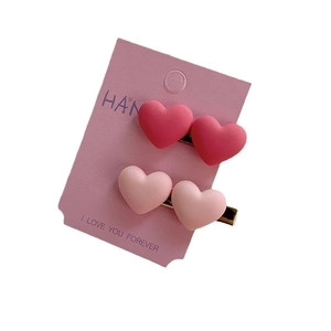 Lot de barrettes coeur rose mat avec finition en métal doré sur carte de support
