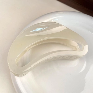 Minimalist large crescent claw clip in elegant creamy white resin for chic hairstyling