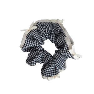 Classic black and white checkered scrunchie with cream ribbon bows and pearl details